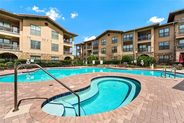 a living room with patio furniture and a large window