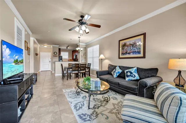 a living room with furniture a dining table and a flat screen tv