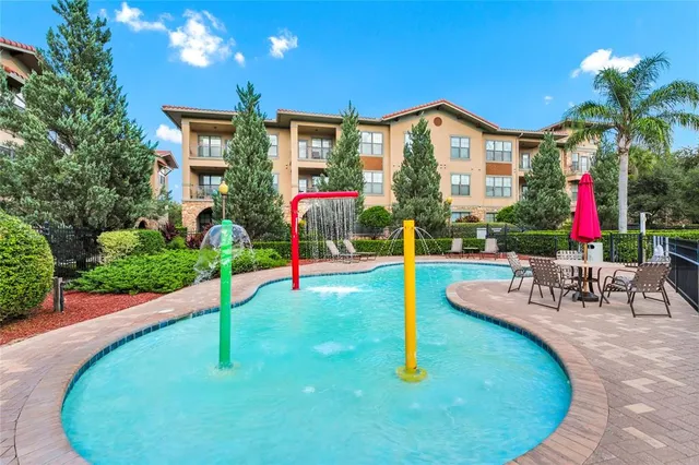 an aerial view of residential houses with outdoor space and river