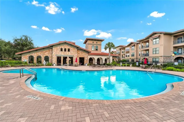 aerial view of a swimming pool with outdoor seating and yard