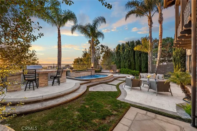 a dining room with furniture potted plants and wooden floor