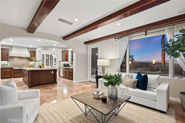 a large kitchen with stainless steel appliances a sink and cabinets