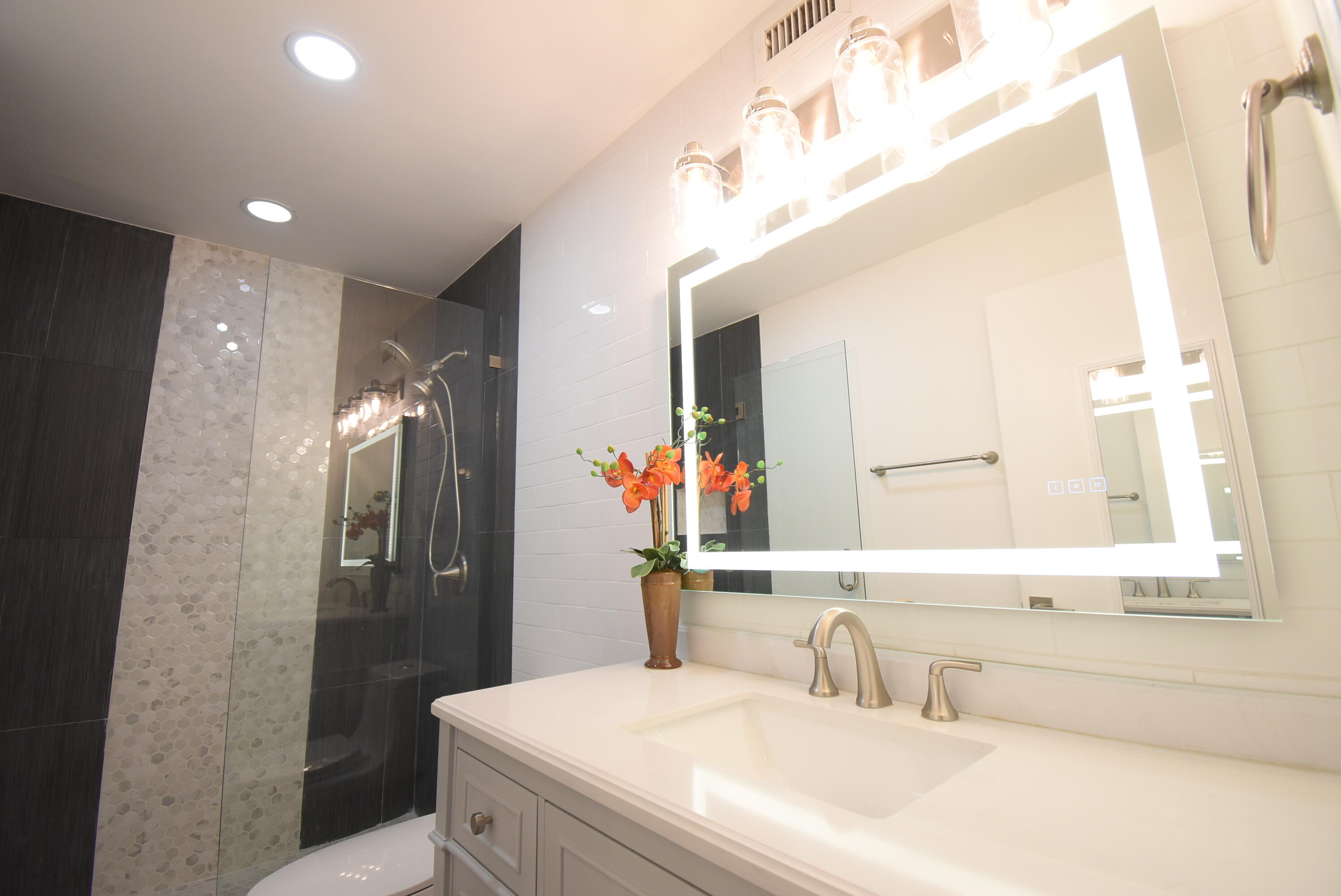 5047 Heatherhill Lane, Unit 60 Boca Raton, FL 33486 - Photo 11 of 34 a bathroom with a sink and a mirror