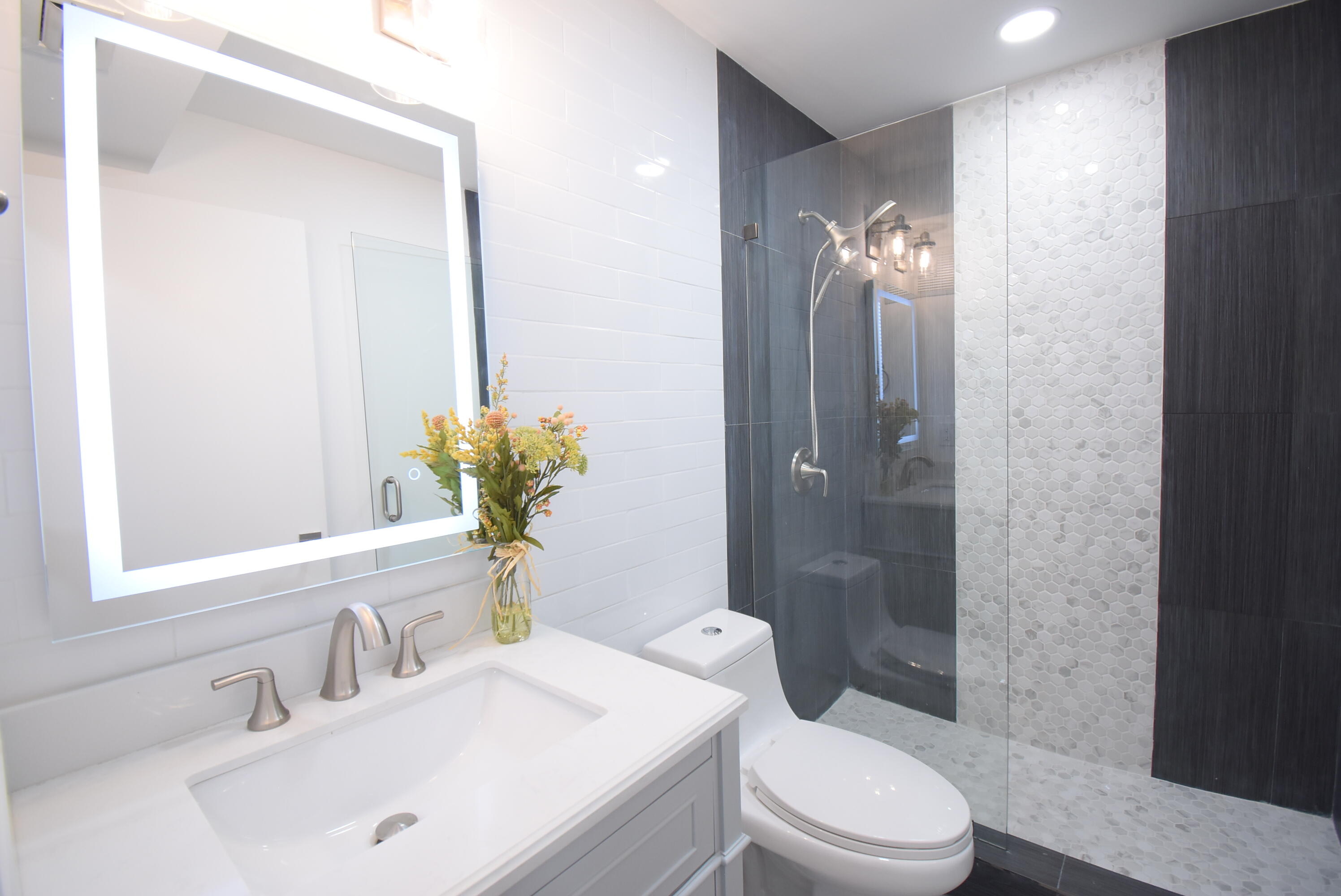 5047 Heatherhill Lane, Unit 60 Boca Raton, FL 33486 - Photo 14 of 34 a bathroom with a sink toilet and shower