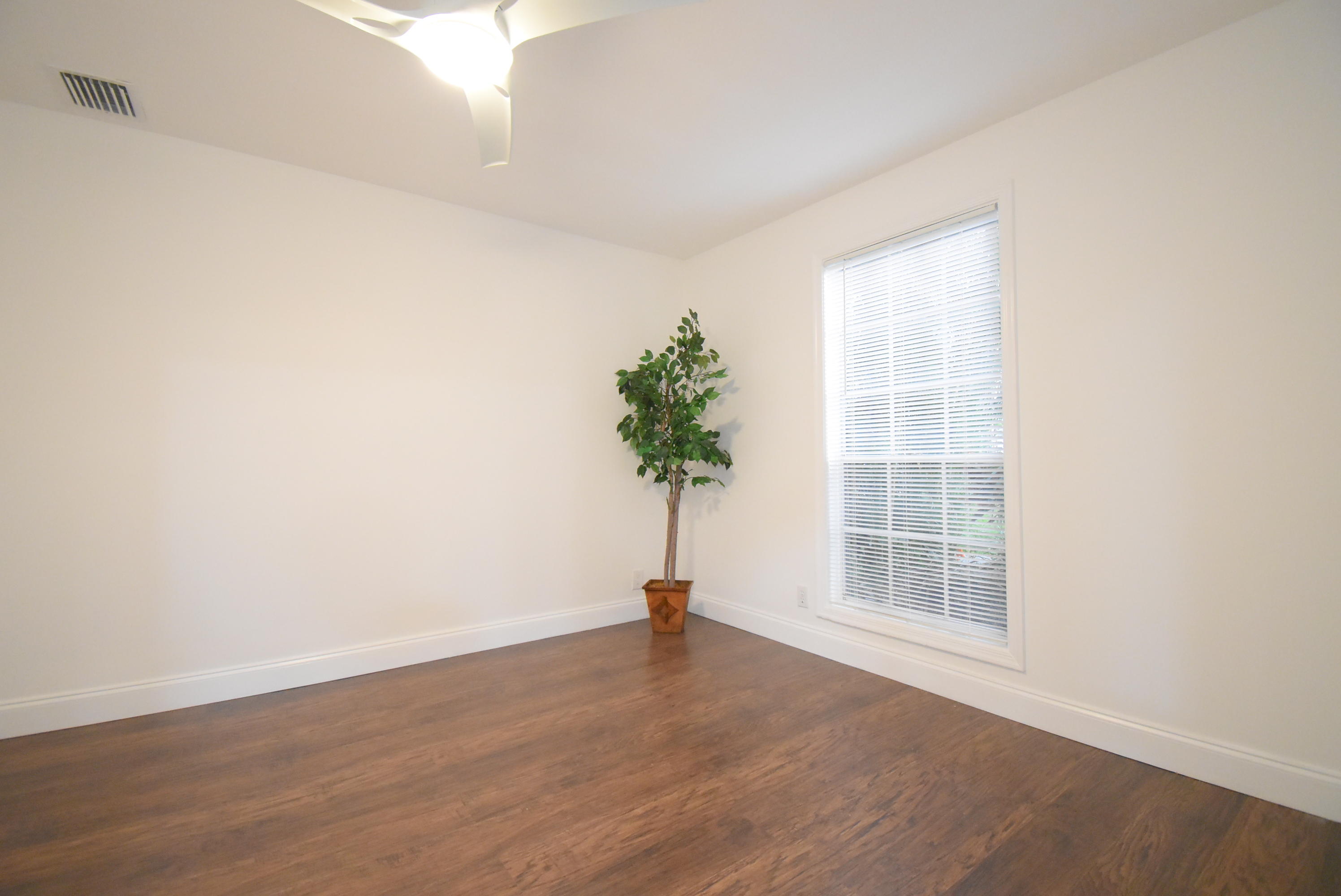 5047 Heatherhill Lane, Unit 60 Boca Raton, FL 33486 - Photo 17 of 34 an empty room with wooden floor and a window