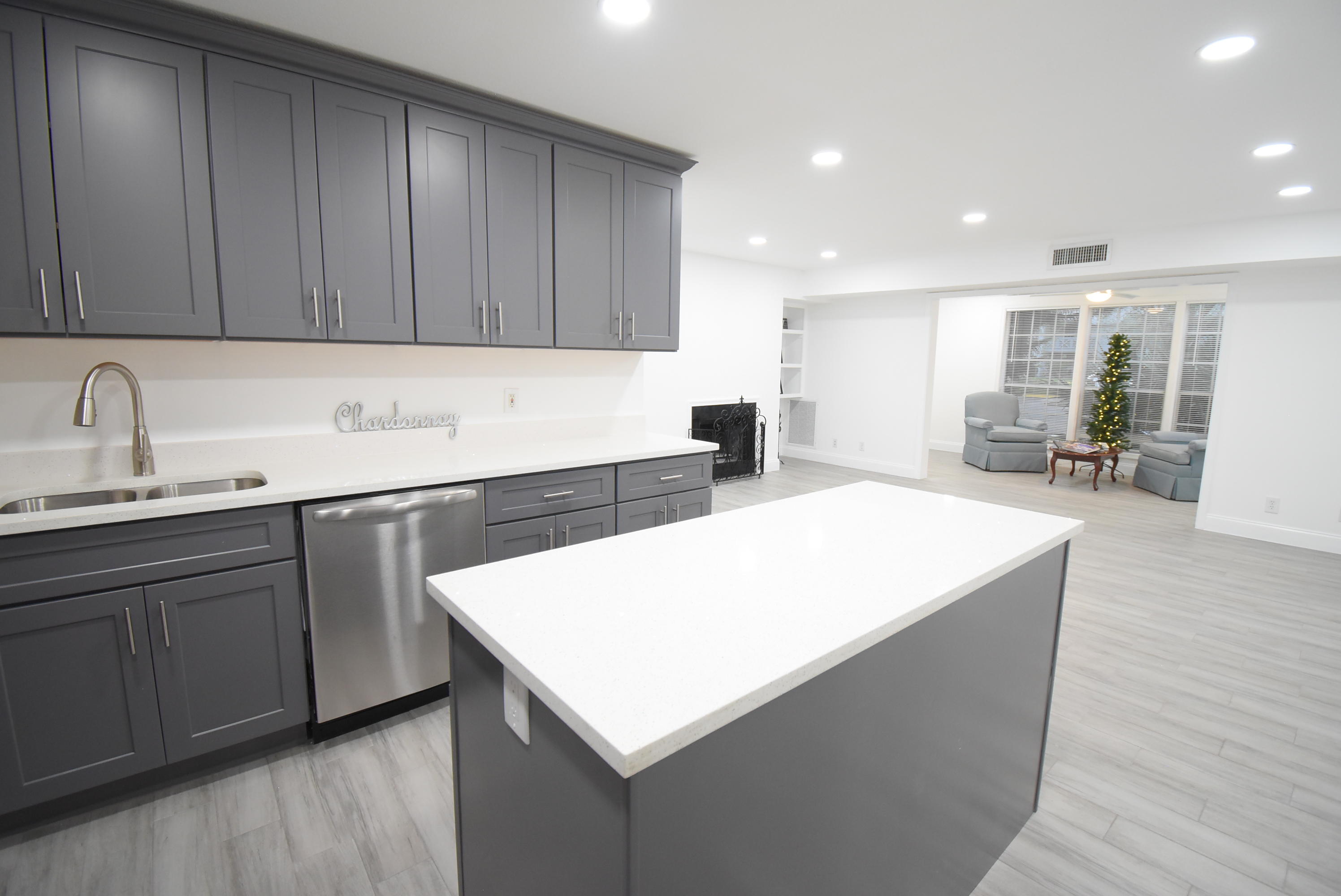 5047 Heatherhill Lane, Unit 60 Boca Raton, FL 33486 - Photo 2 of 34 a kitchen with a sink cabinets and wooden floor