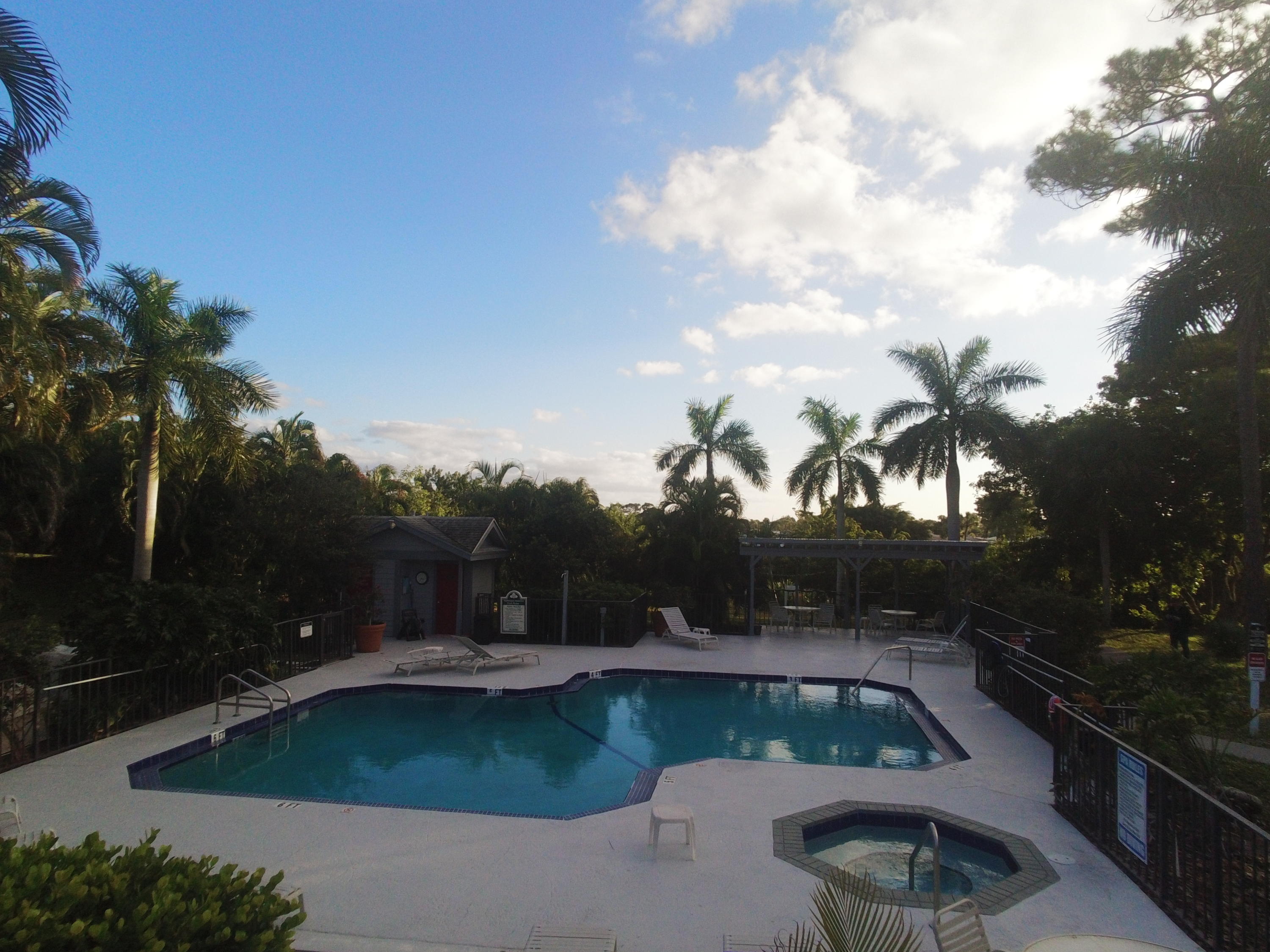 5047 Heatherhill Lane, Unit 60 Boca Raton, FL 33486 - Photo 32 of 34 a view of a swimming pool with a yard
