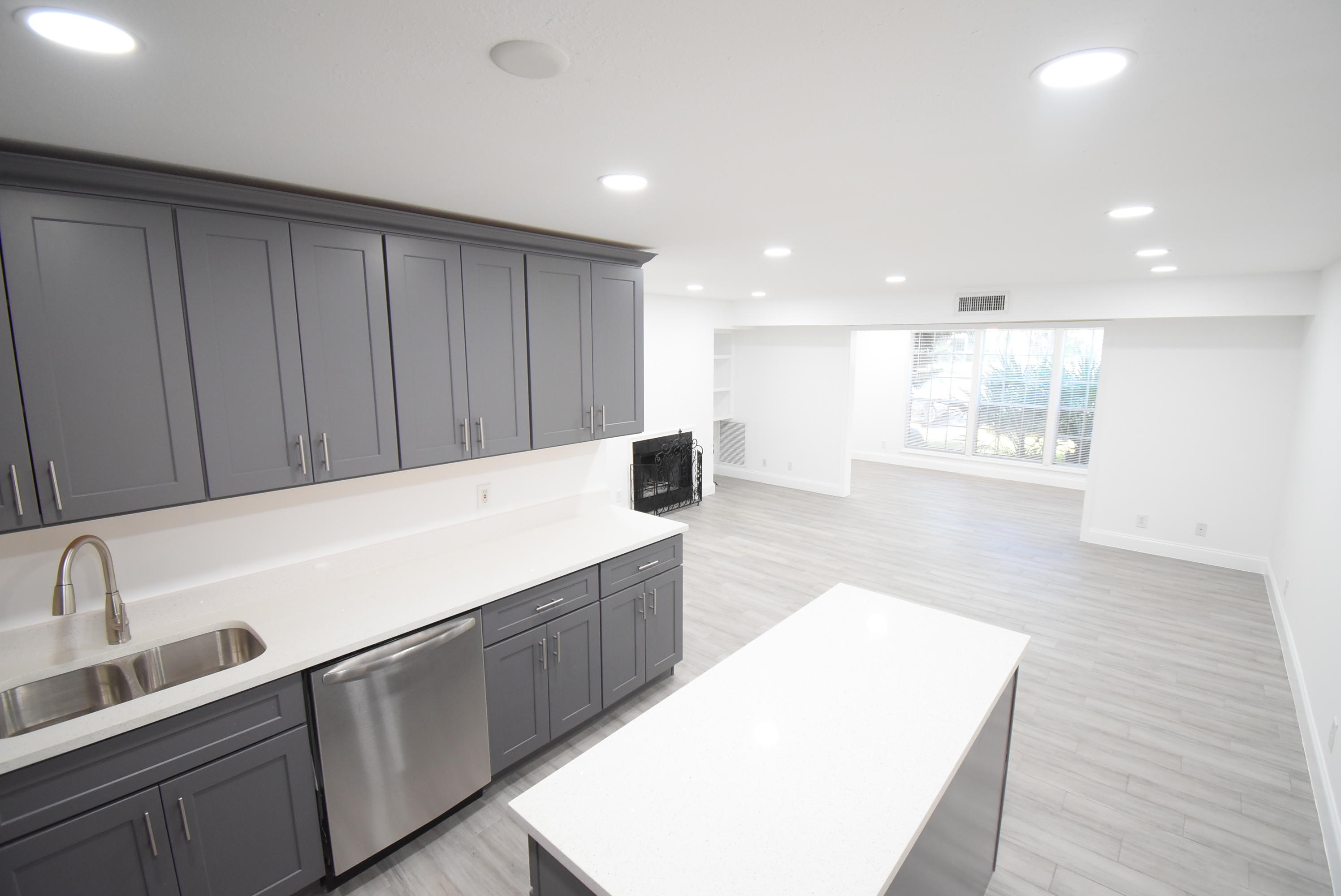 5047 Heatherhill Lane, Unit 60 Boca Raton, FL 33486 - Photo 5 of 34 a kitchen with kitchen island a sink a stove and a wooden floors