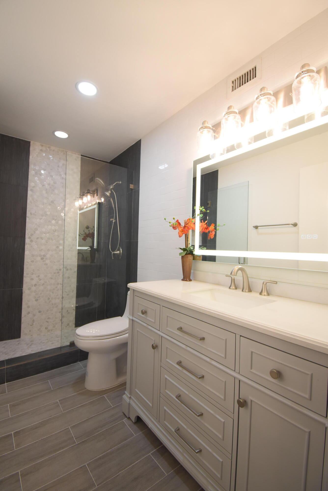 5047 Heatherhill Lane, Unit 60 Boca Raton, FL 33486 - Photo 10 of 34 a bathroom with a toilet sink and shower
