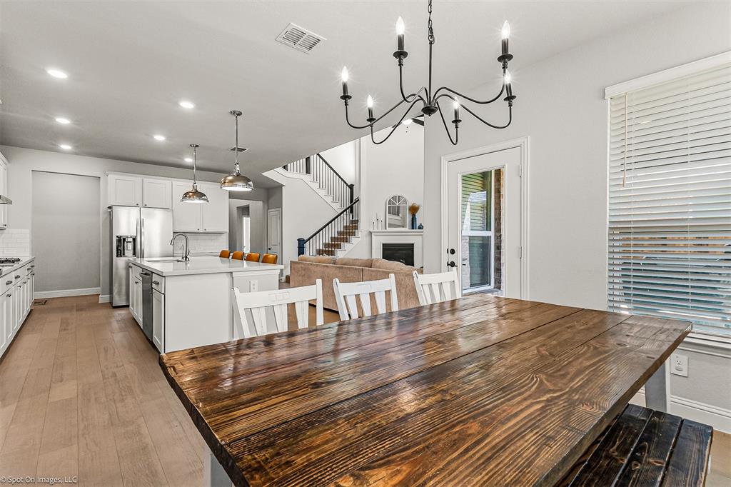 904 Vineyard Way Forney, TX 75126 - Photo 13 of 38 a view of a room with wooden floor and way to kitchen