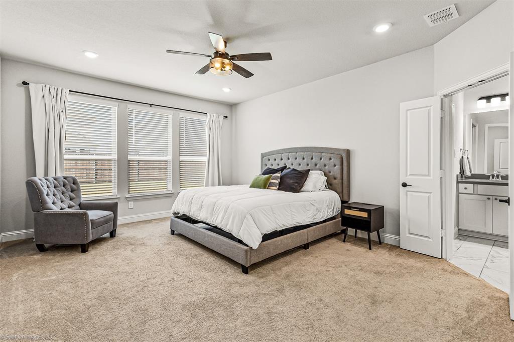 904 Vineyard Way Forney, TX 75126 - Photo 14 of 38 a bedroom with a bed and a couch