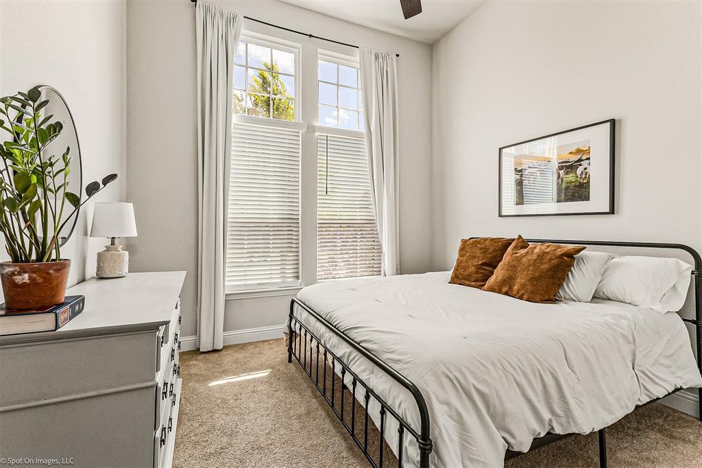 904 Vineyard Way Forney, TX 75126 - Photo 16 of 38 a bedroom with a bed and a potted plant