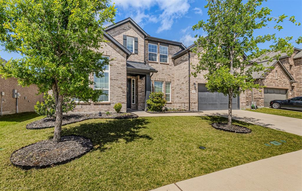 904 Vineyard Way Forney, TX 75126 - Photo 2 of 38 a front view of a house with garden