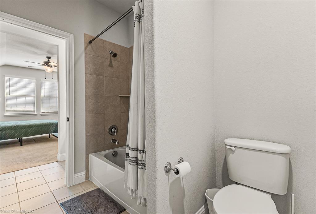 904 Vineyard Way Forney, TX 75126 - Photo 28 of 38 a bathroom with a toilet a sink a mirror and bathtub