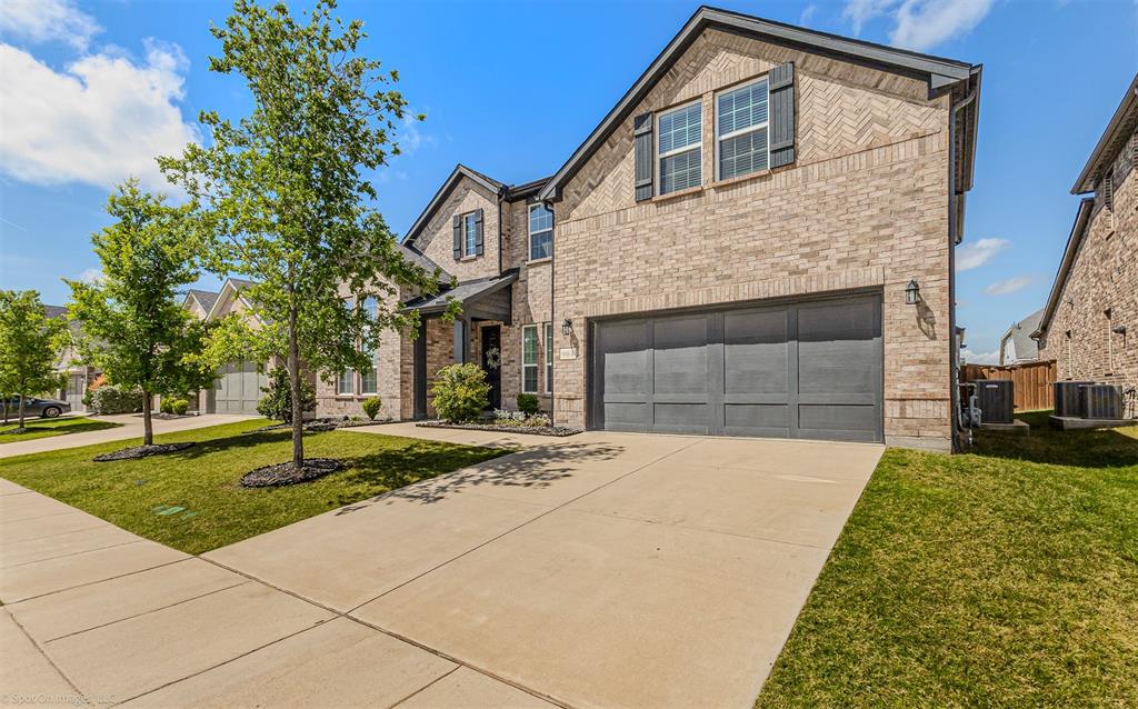 904 Vineyard Way Forney, TX 75126 - Photo 3 of 38 a front view of a house with a garden and trees