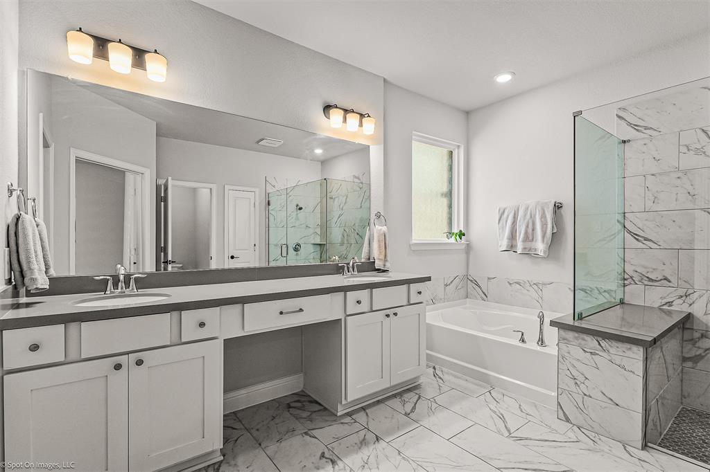 904 Vineyard Way Forney, TX 75126 - Photo 35 of 38 a large white bathroom with a large tub sink and vanity