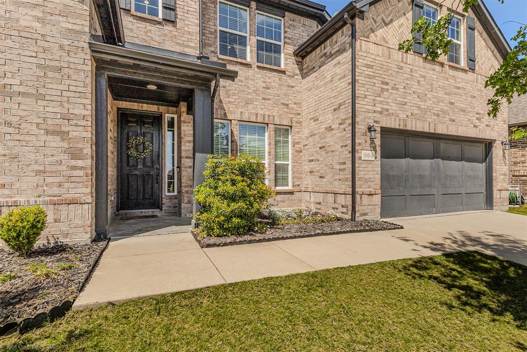 904 Vineyard Way Forney, TX 75126 - Photo 4 of 38 front view of a brick house with a yard