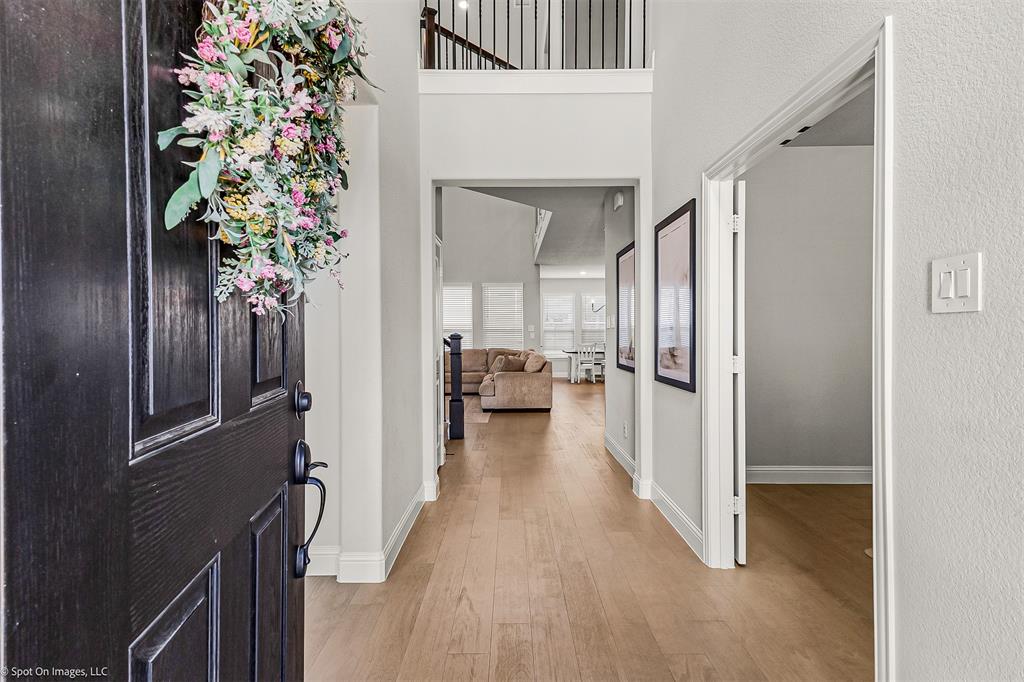 904 Vineyard Way Forney, TX 75126 - Photo 5 of 38 a view of hallway with livingroom and wooden floor