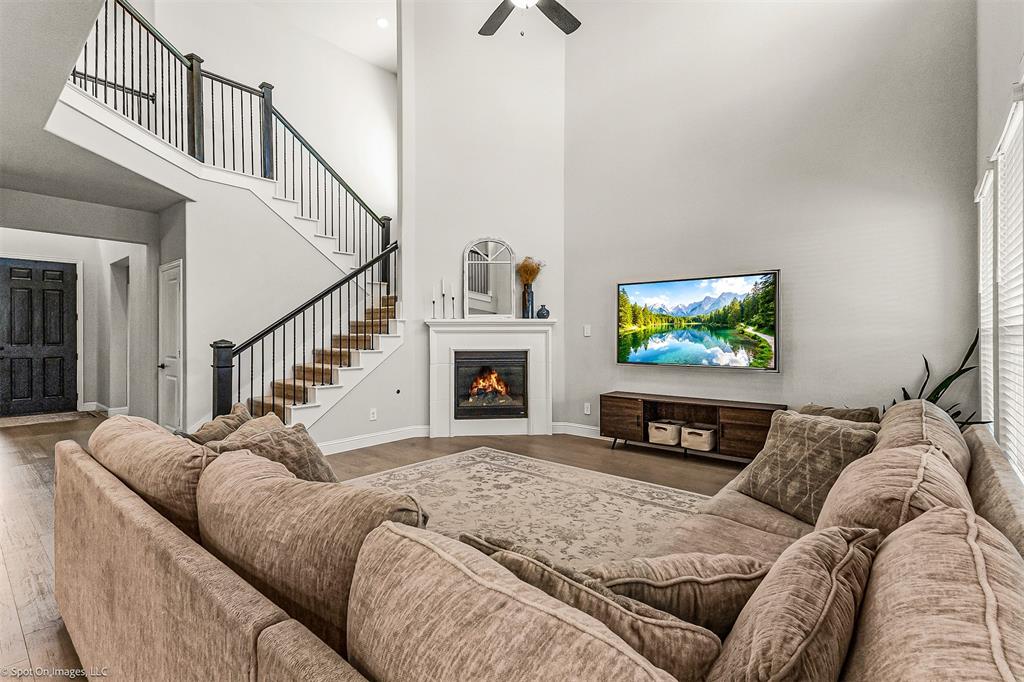 904 Vineyard Way Forney, TX 75126 - Photo 8 of 38 a living room with furniture a flat screen tv and a fireplace