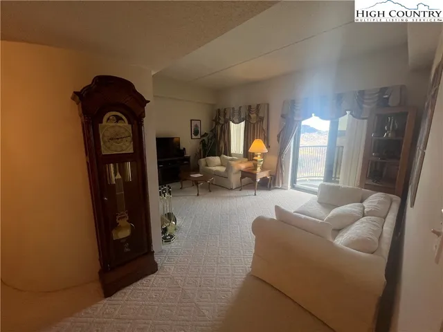 a living room with furniture and a mirror