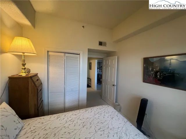 a bedroom with a bed and a mirror