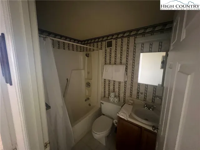 a bathroom with a shower toilet and sink