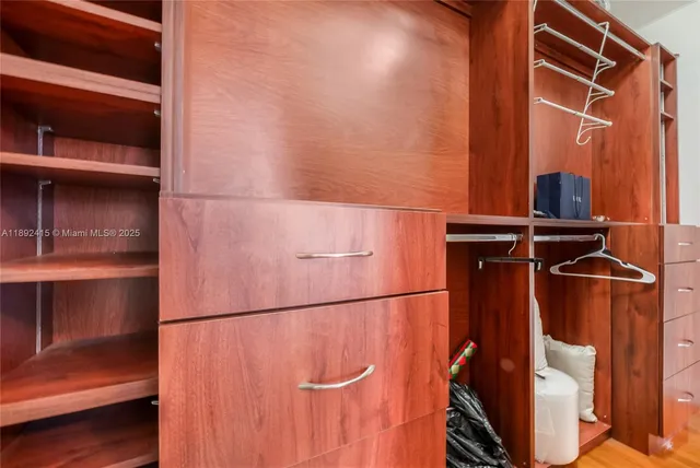 a bedroom with a bed and next to a window