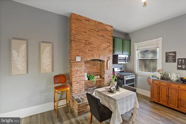 a kitchen with stainless steel appliances kitchen island granite countertop a stove a sink and a microwave