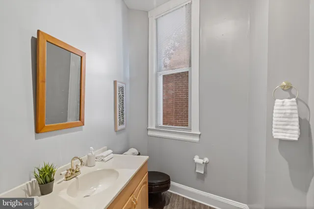 a bathroom with a sink a toilet and a mirror