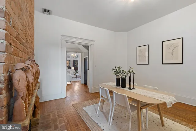 a view of a dining room with furniture wooden floor and a fireplace