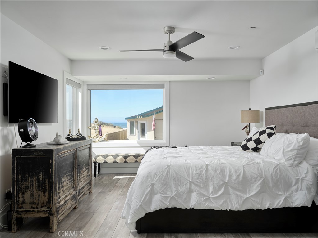 311 Juanita Avenue Oceano, CA 93445 - Photo 14 of 27 a bedroom with a bed and wooden floor