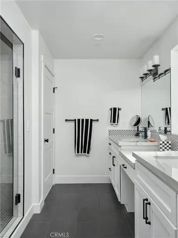 a spacious bathroom with a granite countertop sink and a mirror