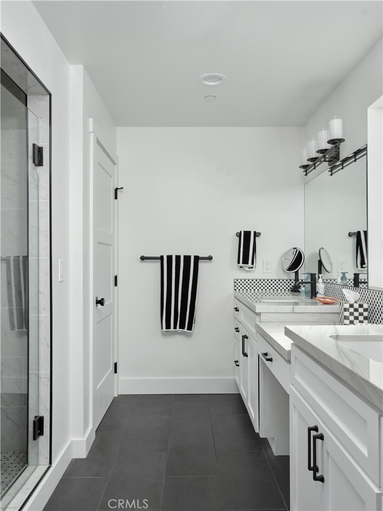311 Juanita Avenue Oceano, CA 93445 - Photo 15 of 27 a spacious bathroom with a granite countertop sink and a mirror