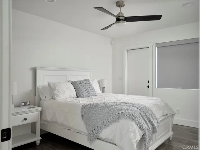 a large bed sitting in a bedroom and chair
