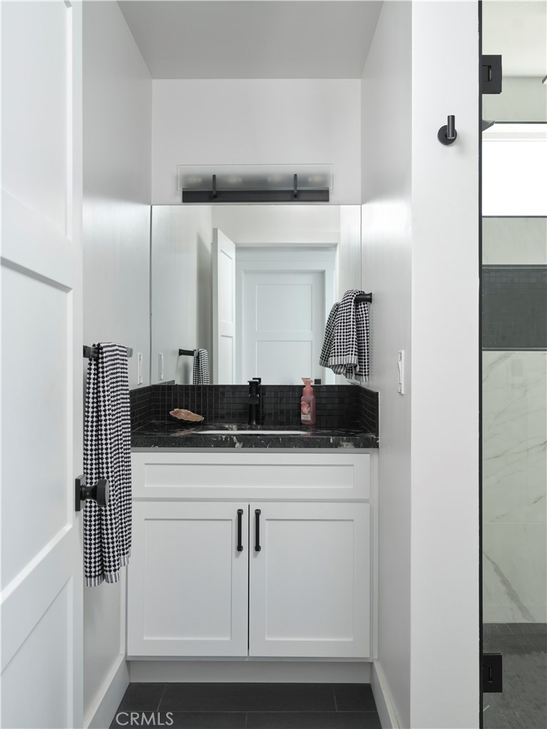 311 Juanita Avenue Oceano, CA 93445 - Photo 21 of 27 a bathroom with a sink and a mirror