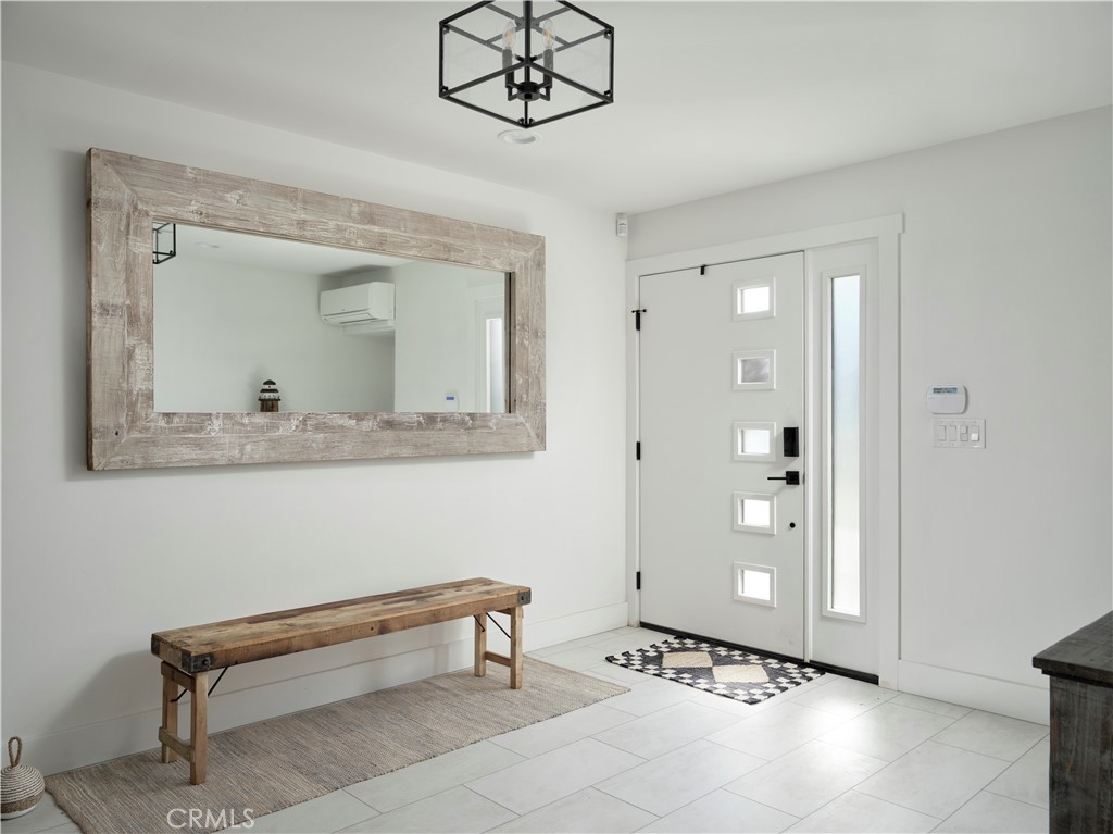 311 Juanita Avenue Oceano, CA 93445 - Photo 23 of 27 a living room with a mirror and a glass door shower