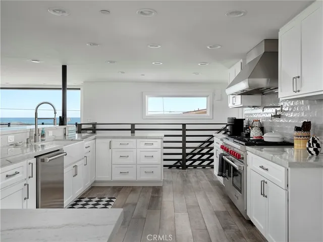 a kitchen with granite countertop a sink and cabinets