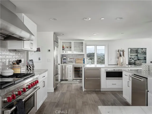 a kitchen with stainless steel appliances and white cabinets