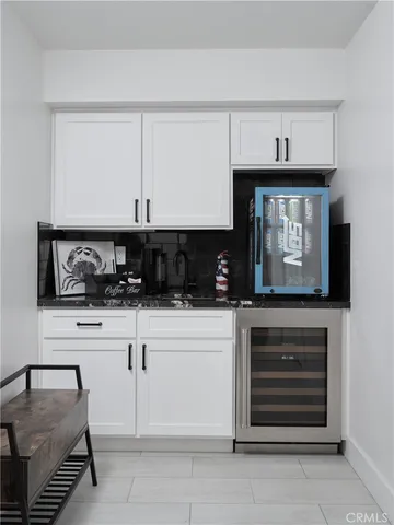 a kitchen with granite countertop white cabinets and stainless steel appliances