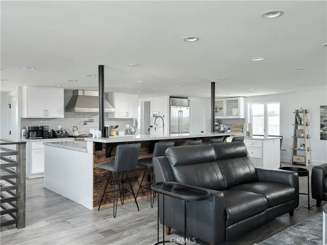 a living room with furniture and kitchen view