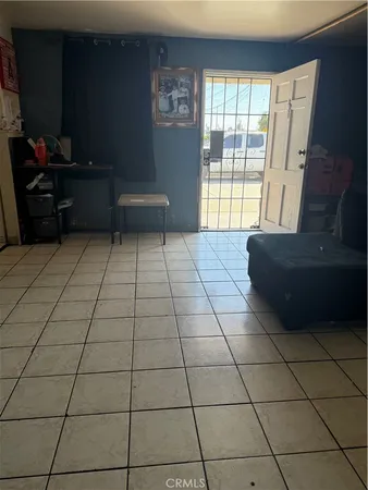 a living room with a couch and a floor to ceiling window