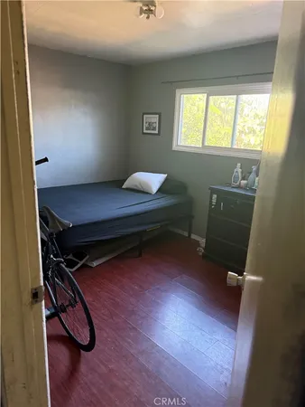 a room with gym equipment on wooden floor