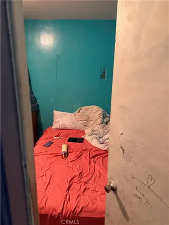 a bed with green sheets and pillows on it