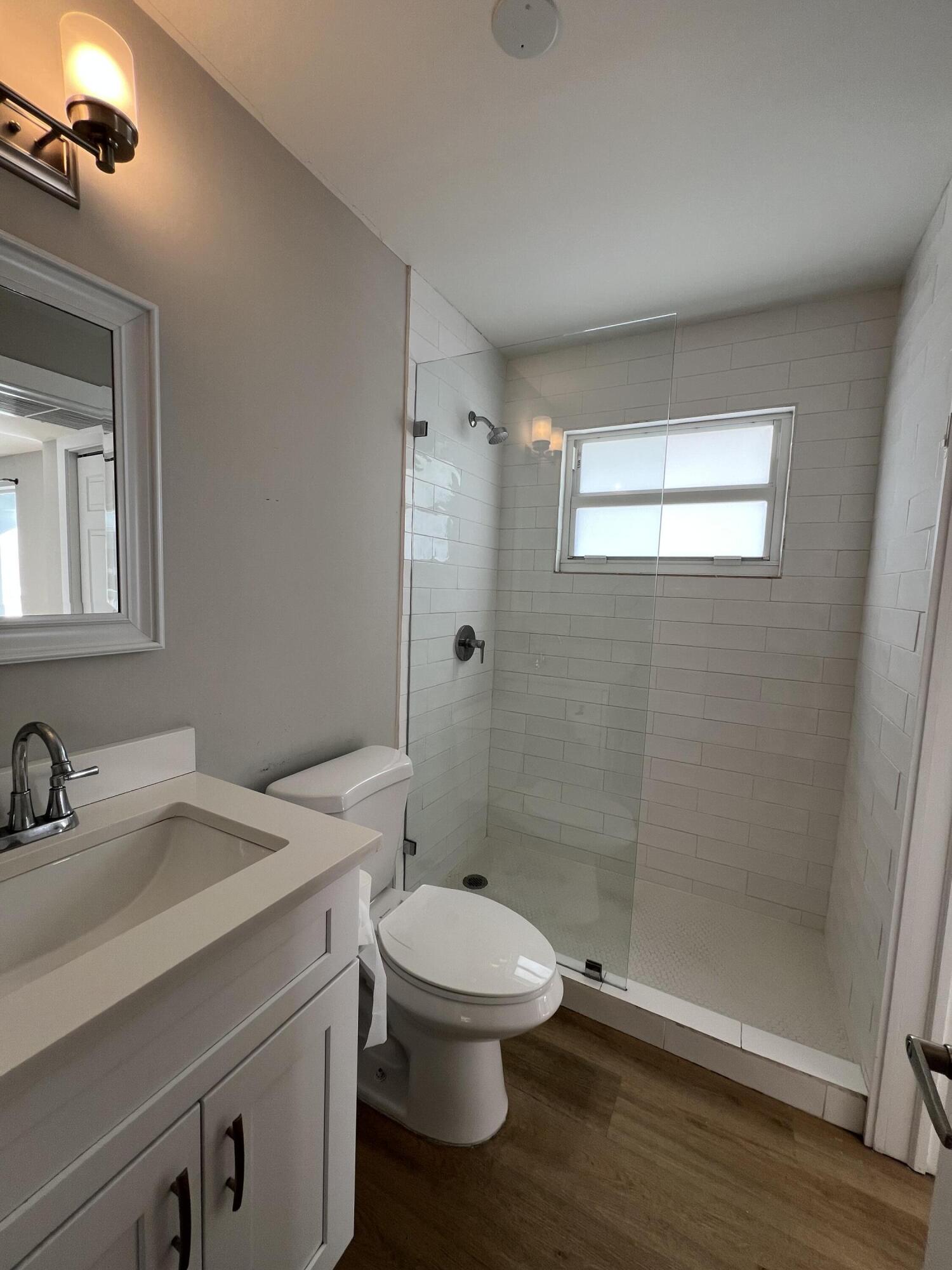 6600 North Ocean Boulevard, Unit 16 Ocean Ridge, FL 33435 - Photo 12 of 21 a bathroom with a sink a toilet and shower