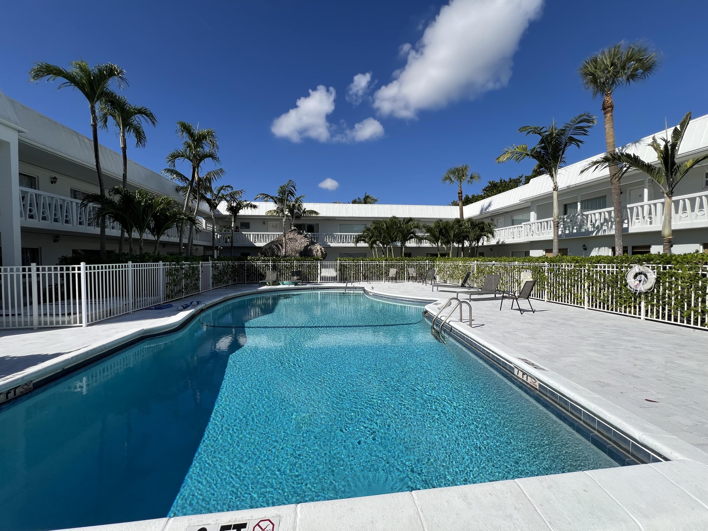 6600 North Ocean Boulevard, Unit 16 Ocean Ridge, FL 33435 - Photo 18 of 21 a view of a swimming pool with an outdoor seating
