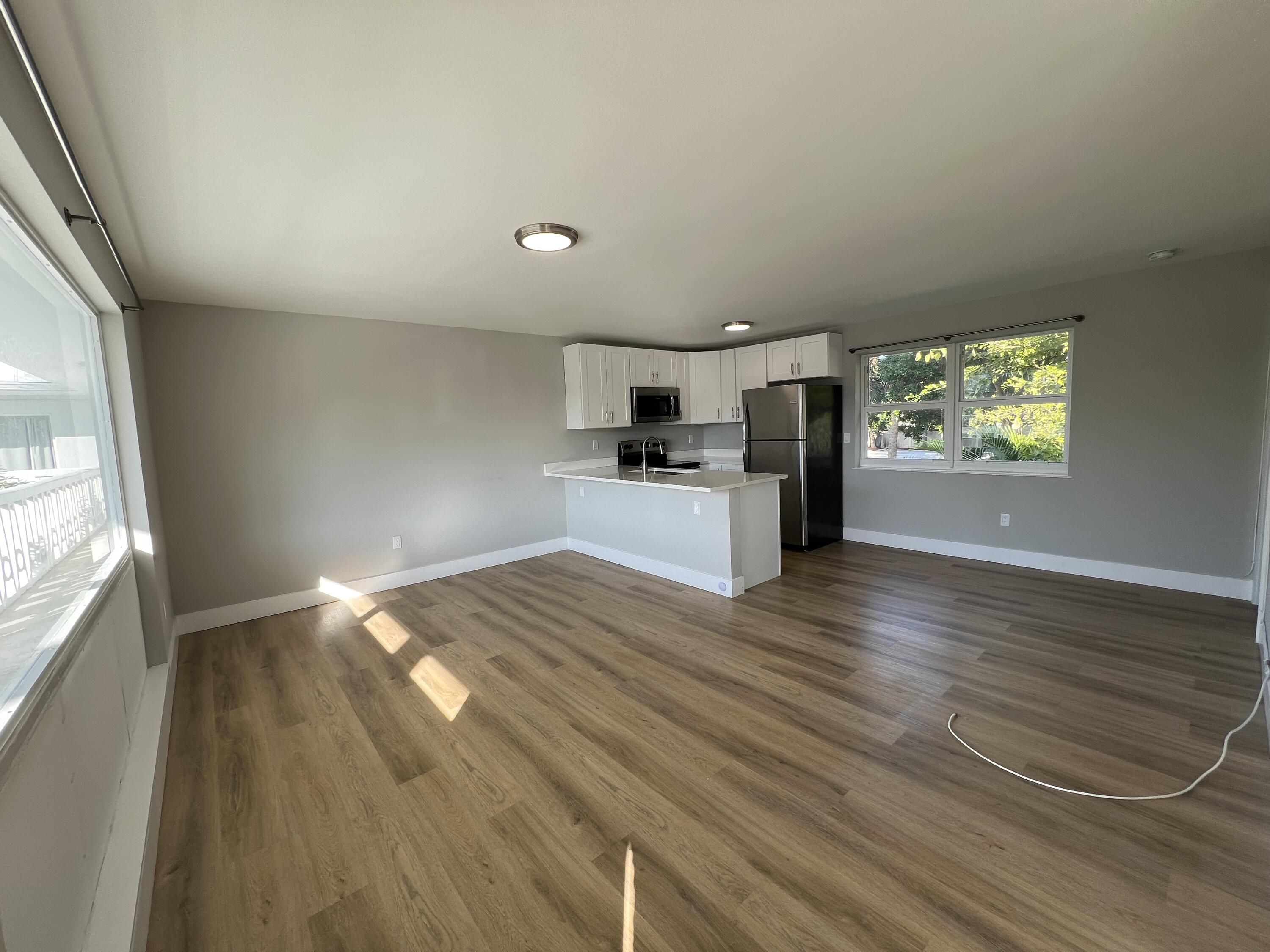 6600 North Ocean Boulevard, Unit 16 Ocean Ridge, FL 33435 - Photo 2 of 21 wooden floor in an empty room with a window