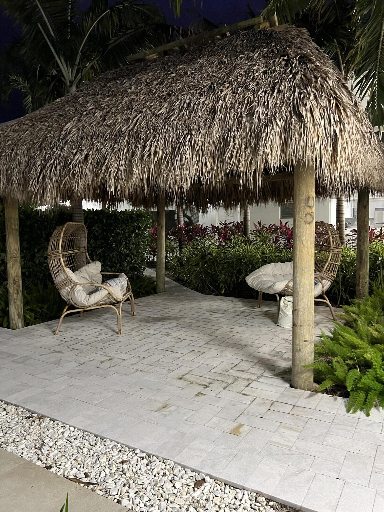 6600 North Ocean Boulevard, Unit 16 Ocean Ridge, FL 33435 - Photo 21 of 21 a view of a chair and tables in the patio