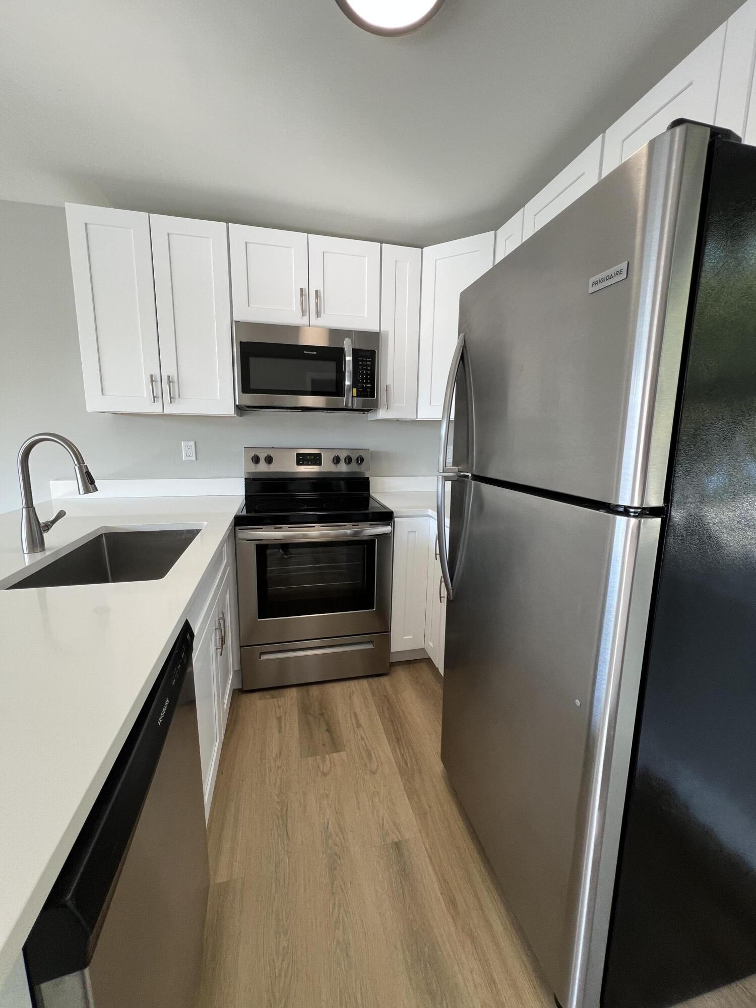 6600 North Ocean Boulevard, Unit 16 Ocean Ridge, FL 33435 - Photo 7 of 21 a kitchen with stainless steel appliances a refrigerator sink and cabinets