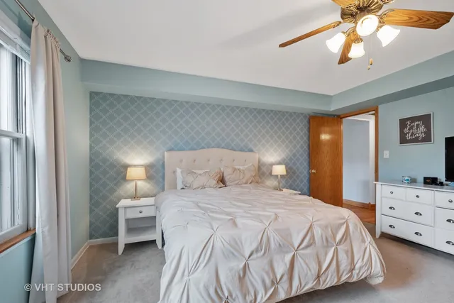 a bedroom with a bed and a chandelier