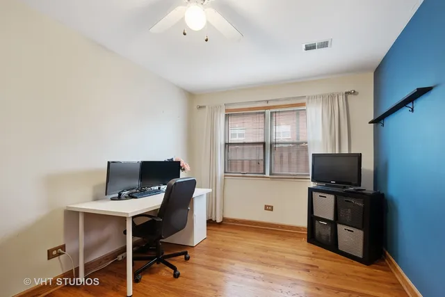 a view of a workspace with furniture and a window